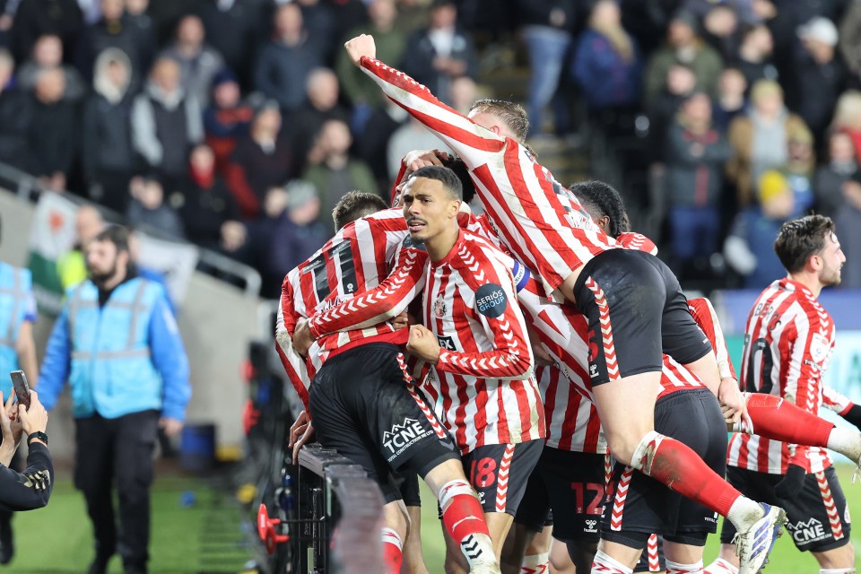 Jobe wrapped his arm around Rigg's back to stop him falling during the celebrations